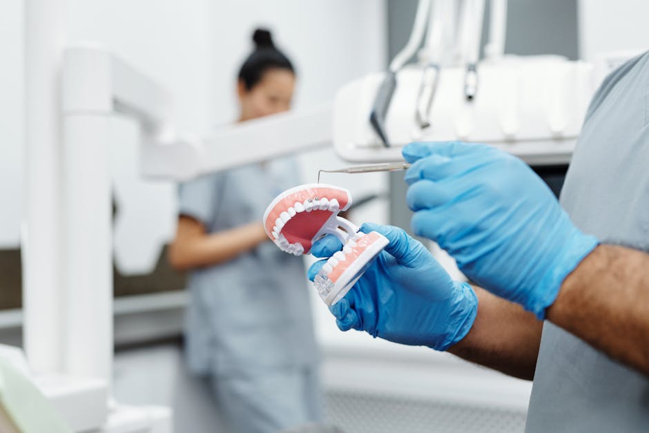 Dr. Donald H. Oga explaining Invisalign treatment to a patient using a dental model