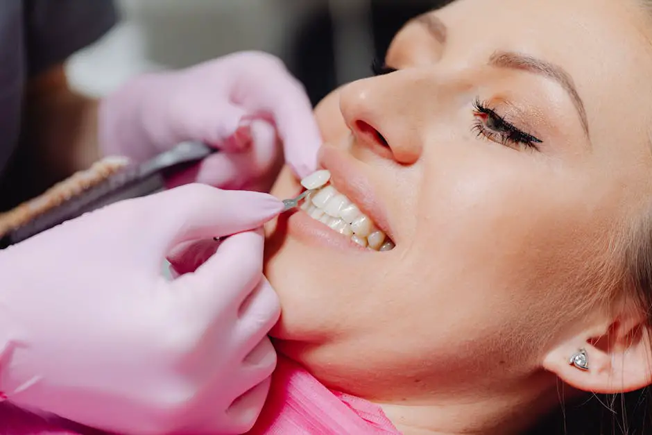 A dentist performing a professional cleaning on a patient with porcelain veneers