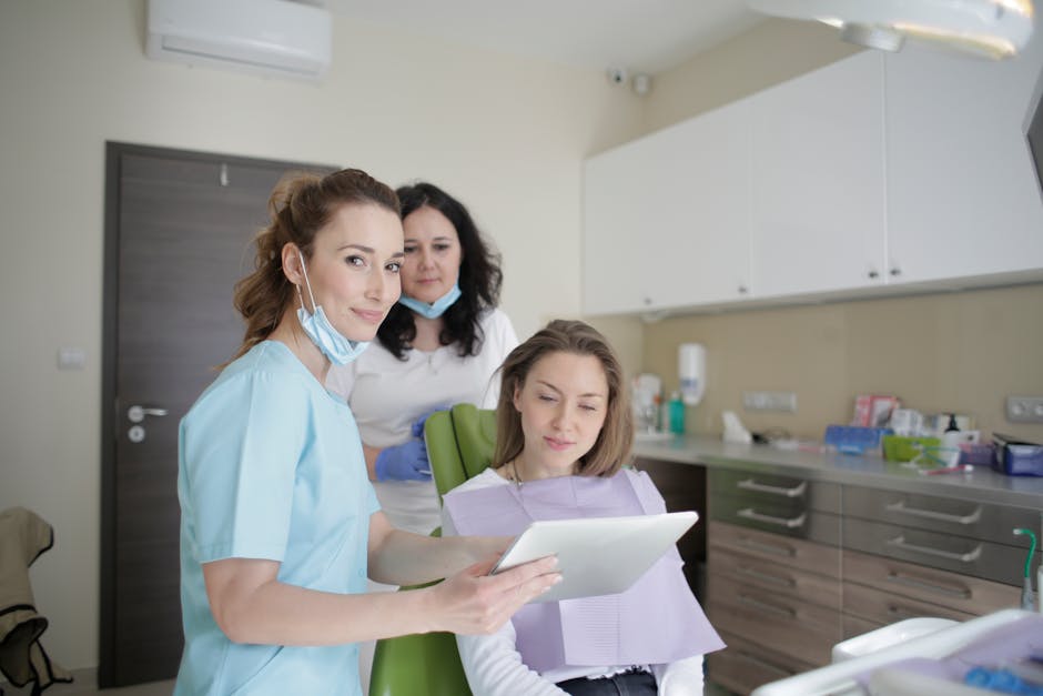 Dental team at Welcome Smile Dental reviewing an Invisalign treatment plan with a patient